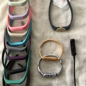 Fitbit Flex 2 with charger and multiple bands.